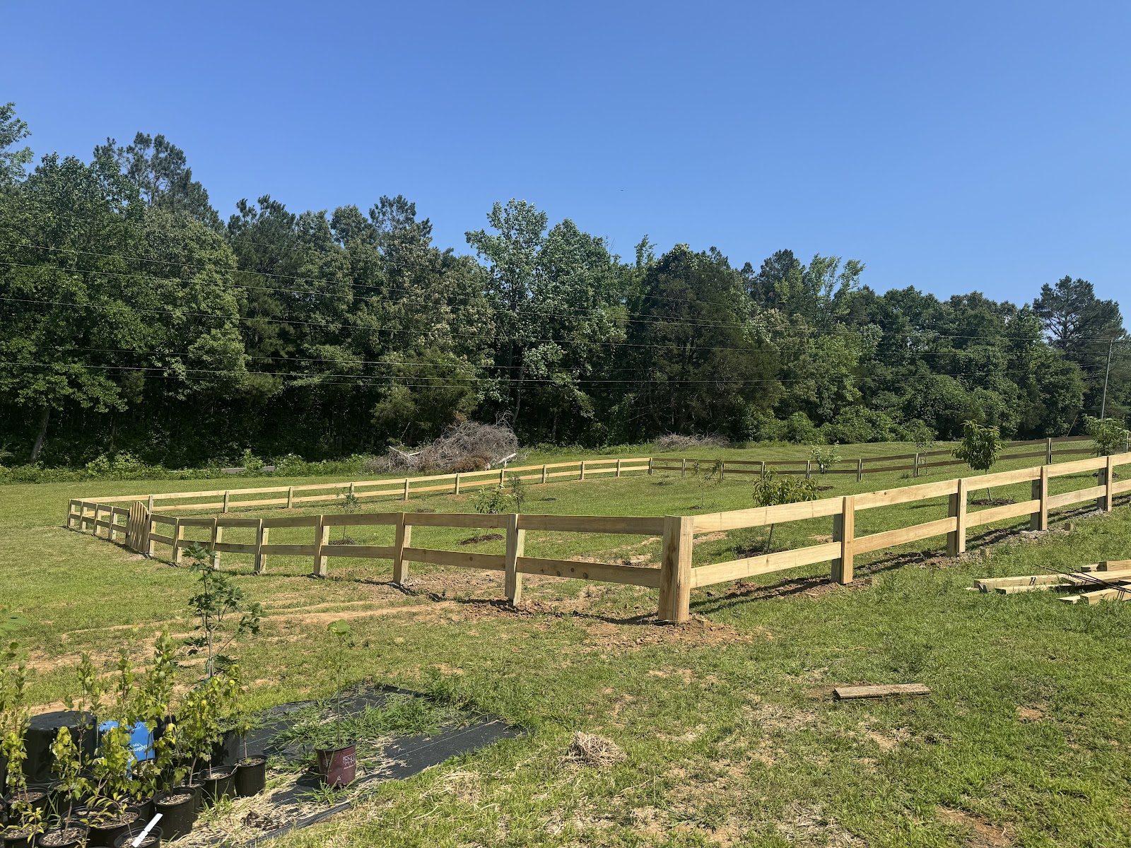 Three-board fence in a field