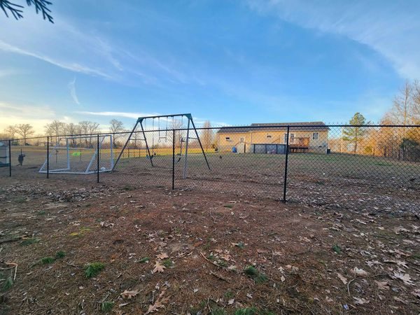 Black chain link fence around a play area
